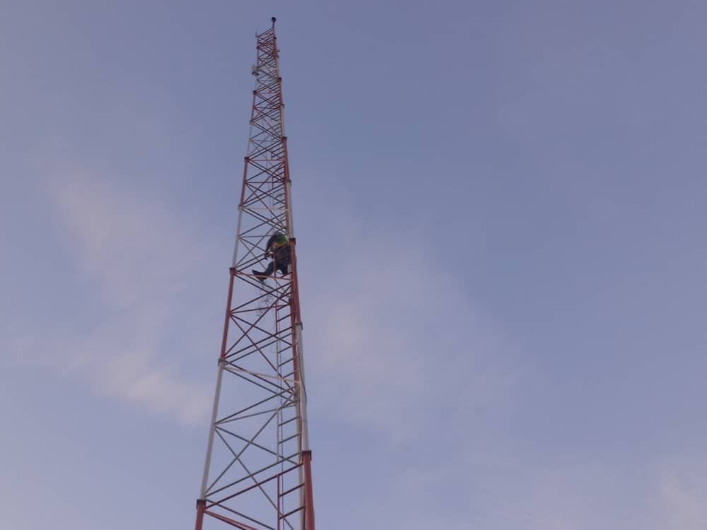 Technician climbing the Bruben community telecommunications tower