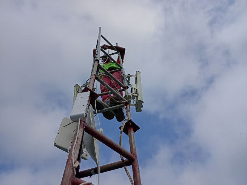 Technician climbing the Samreboi relay tower